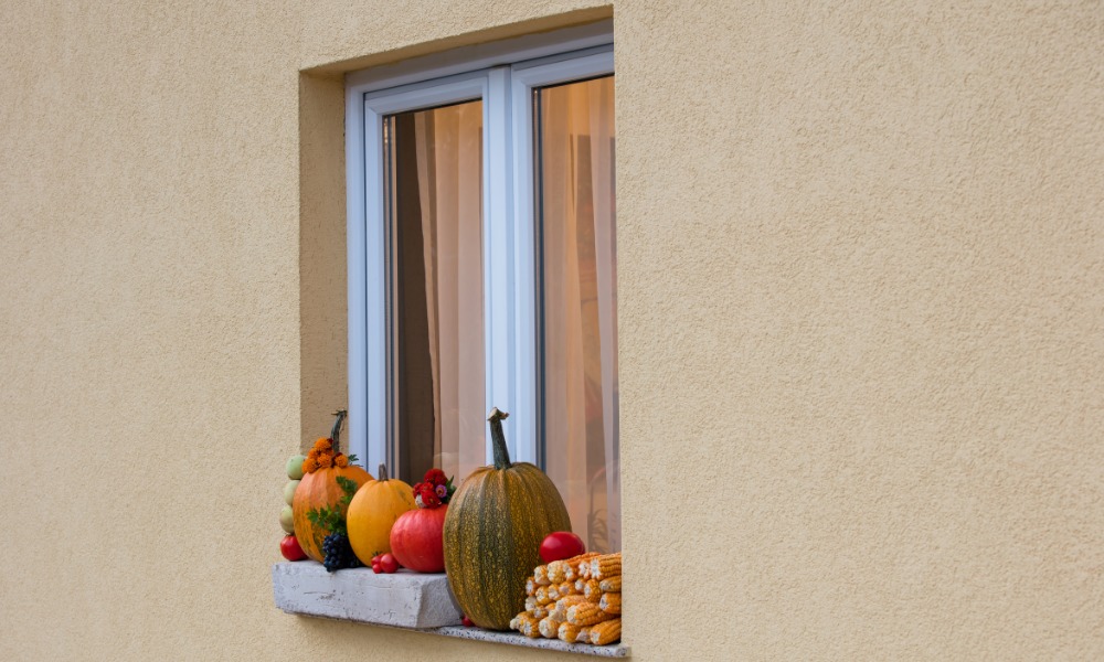 Decorative Gourds on the sill of a white casement window