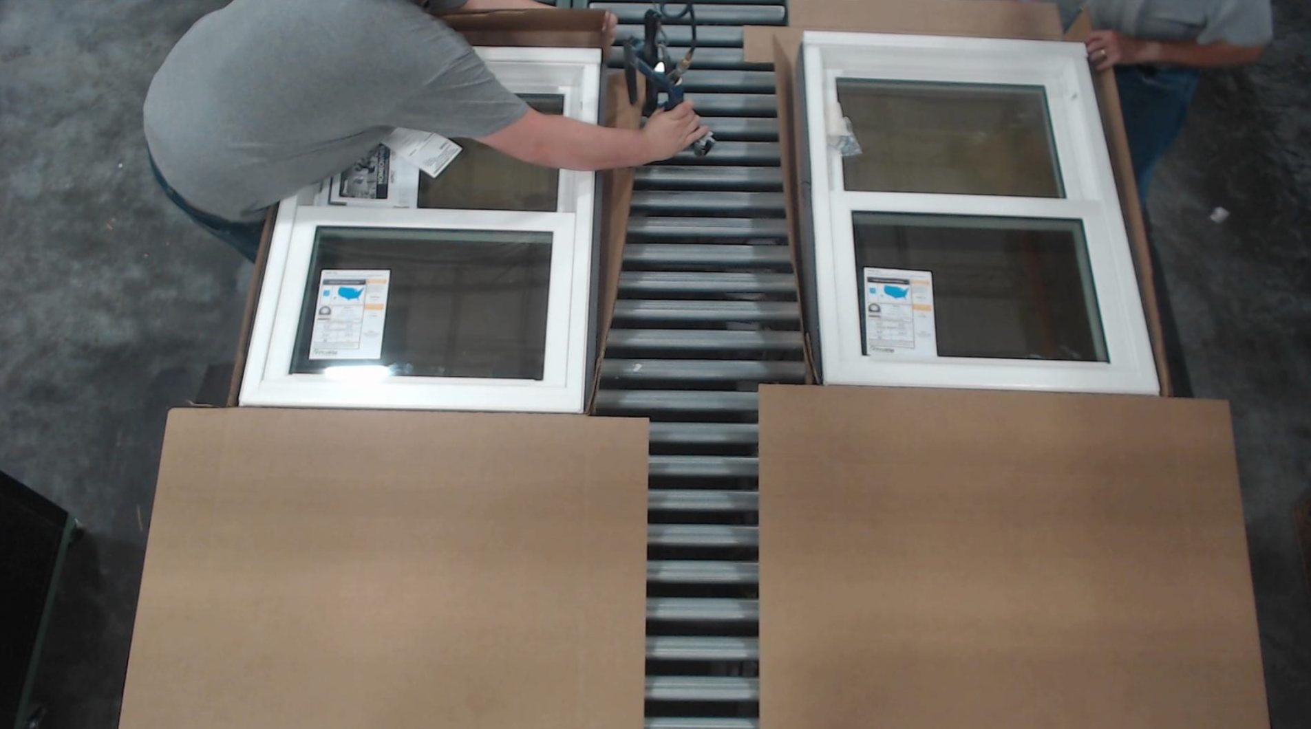 ProVia quality control employee preparing a vinyl window for shipping in a box